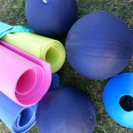 Yoga mats and medicine balls on the grass