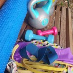 Photo of a selection of fitness equipment on a park bench