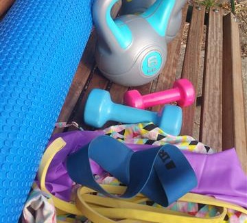 Photo of a selection of fitness equipment on a park bench