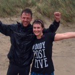 Photo of personal trainer and client after a run at the beach